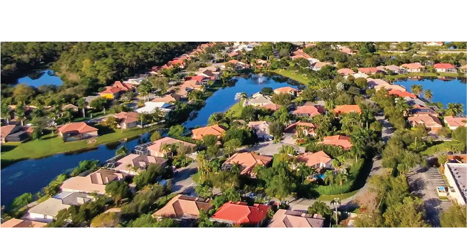 Aerial view of a residential neighborhood with homes, waterways, and lush green landscape - Aqua King Pool Services, Fort Lauderdale, FL