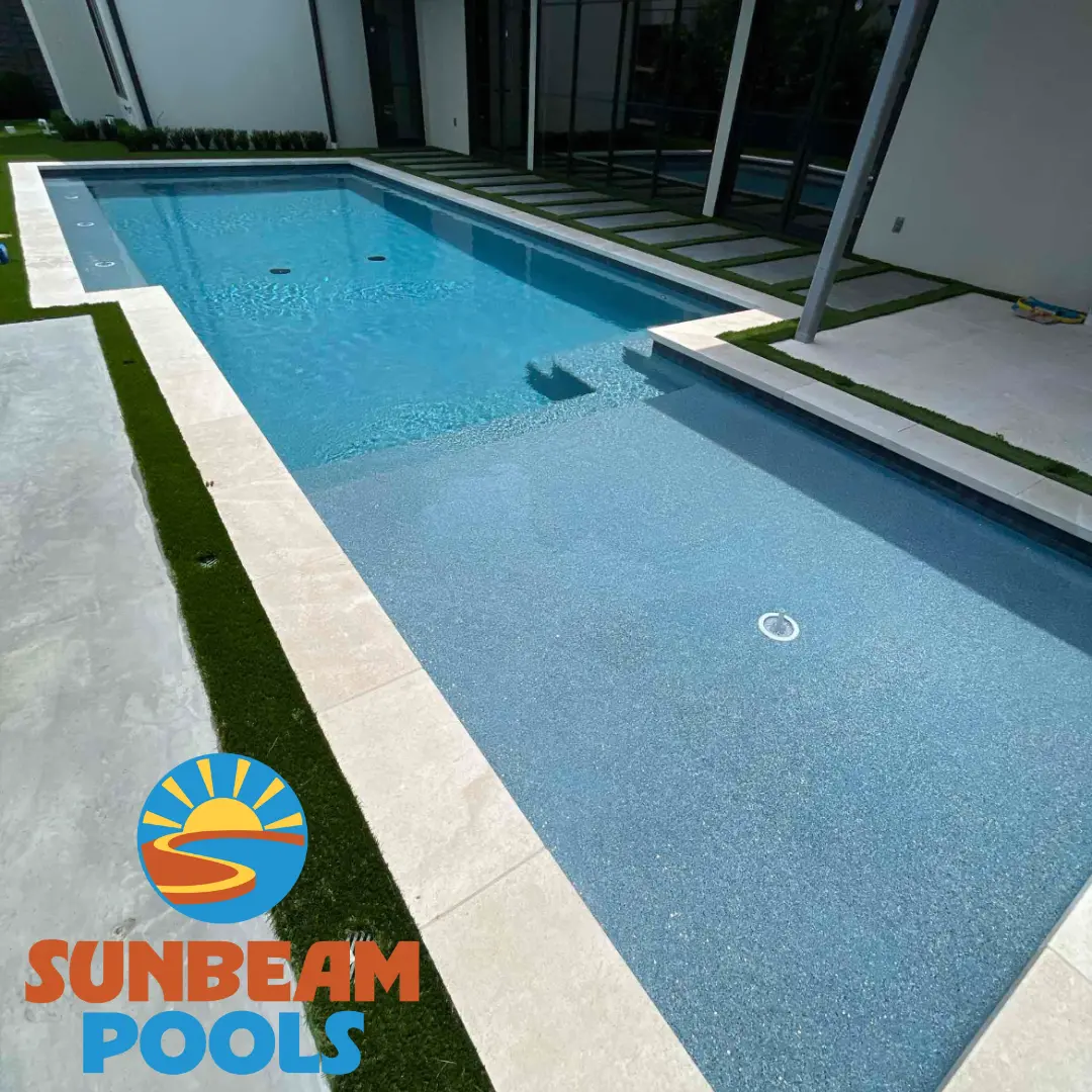 Sparkling clean rectangular pool with white decking and modern patio area - Sunbeam Pools, Dallas, TX